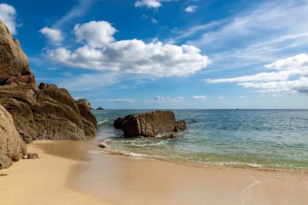 The idyllic beach of Porthcurno, Cornwall, on a summer afternoon