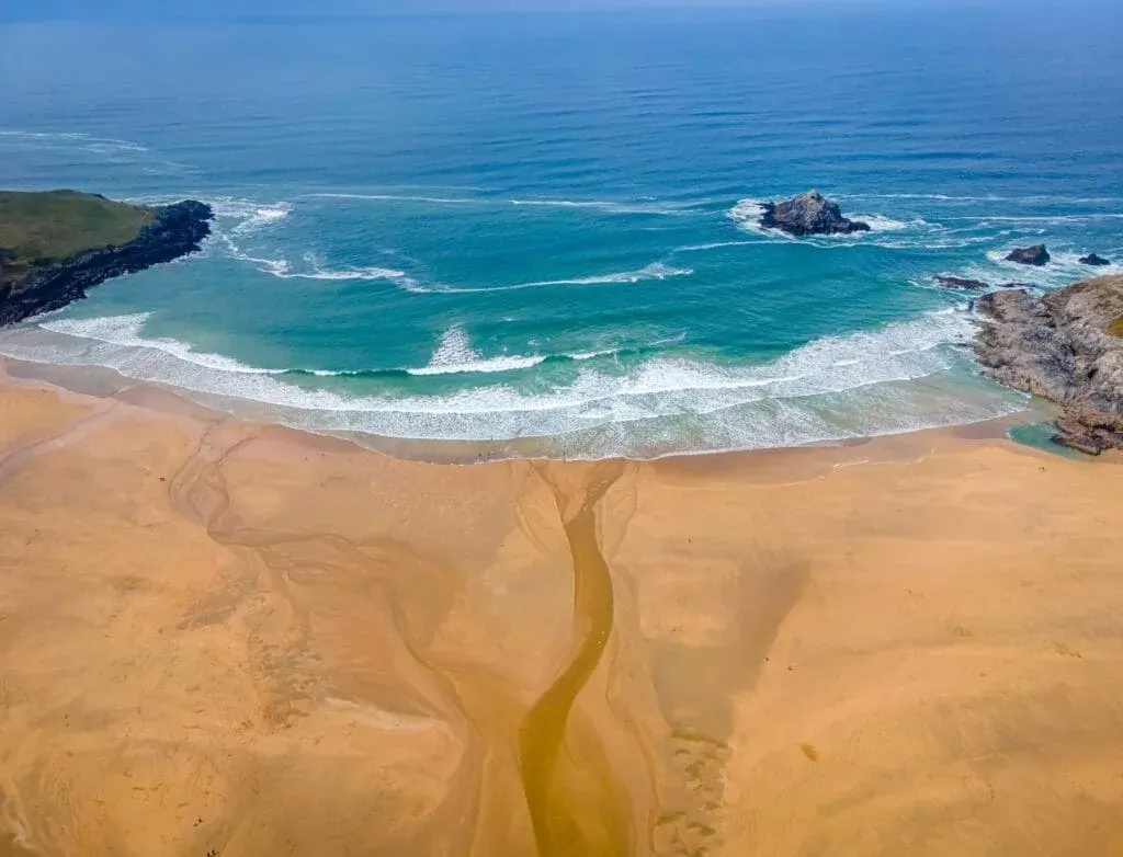 An aerial view of low tide Crantock Beach in Cornwall, UK.