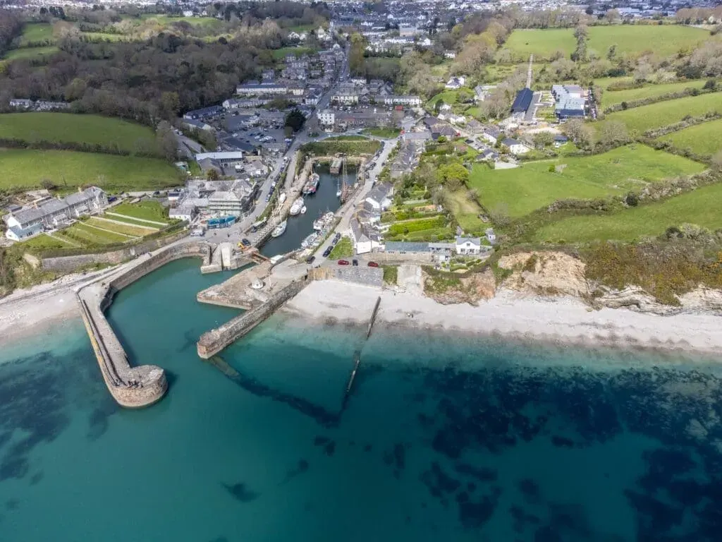 An aerial view of Charleston Beach and Harbour from the air, on the south Cornwall coast