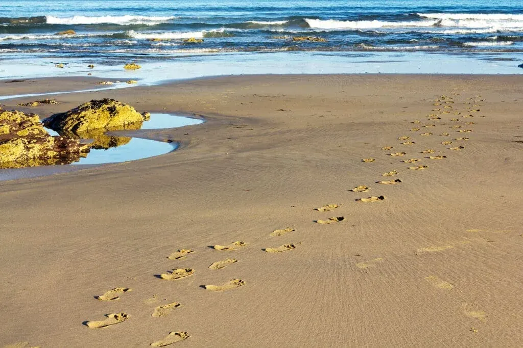 Footprints in the sand on Polzeath Beach, Cornwall