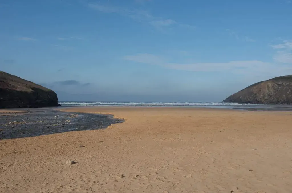 A quiet early morning on the sandy beach at Mawgan Porth, Cornwall