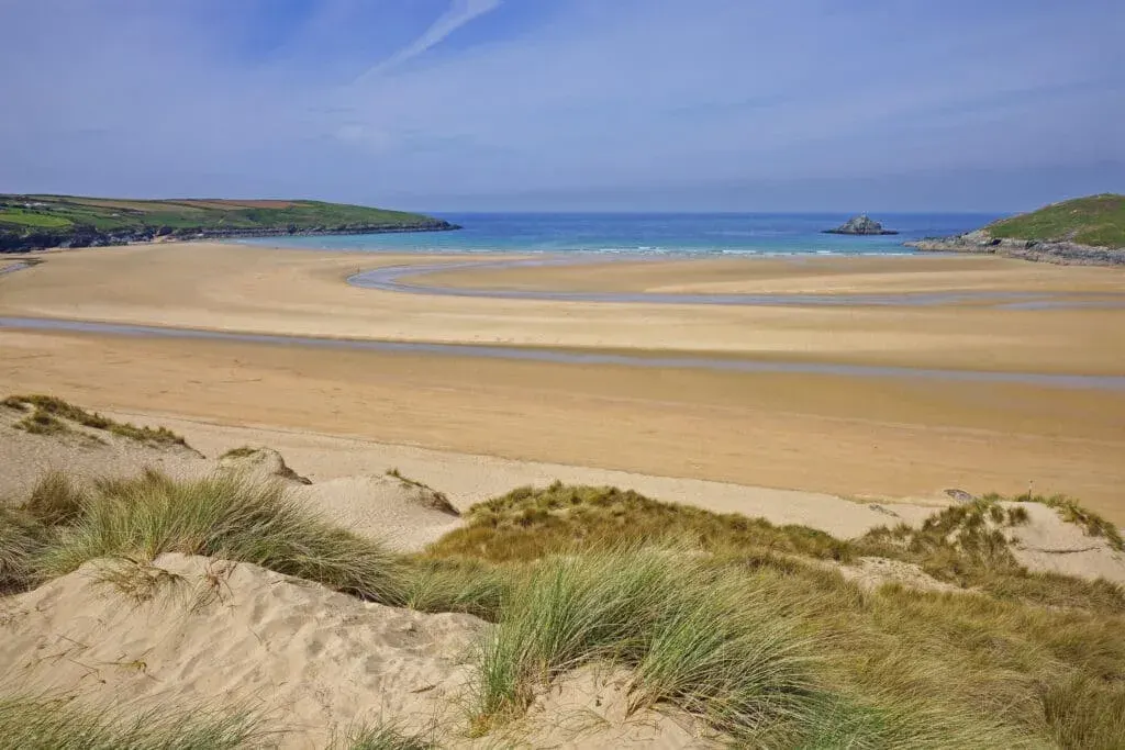 The sand dunes at Crantock Beach, Cornwall, and an incoming tides