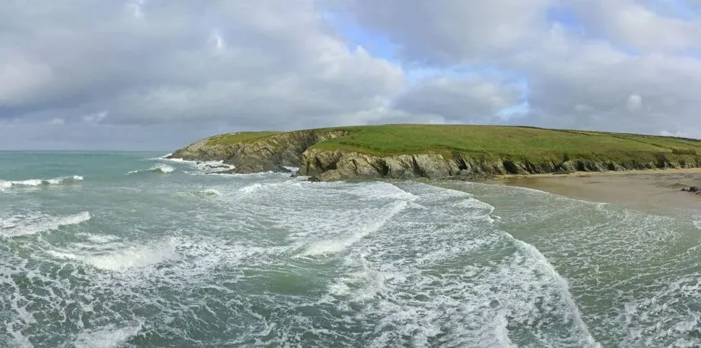 A panorama view of Polly Joke Beach (also known as Porth Joke) on the rugged North Cornish coast.