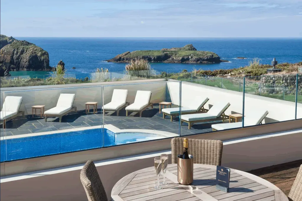 Outdoor pool and sun loungers with a sea view, Mullion Cove Hotel & Spa, Cornwall