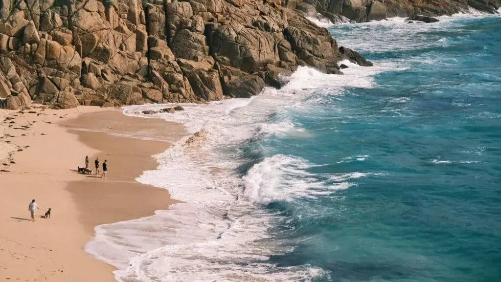An aerial view of a sunny day at Porthcurno Beach, Cornwall